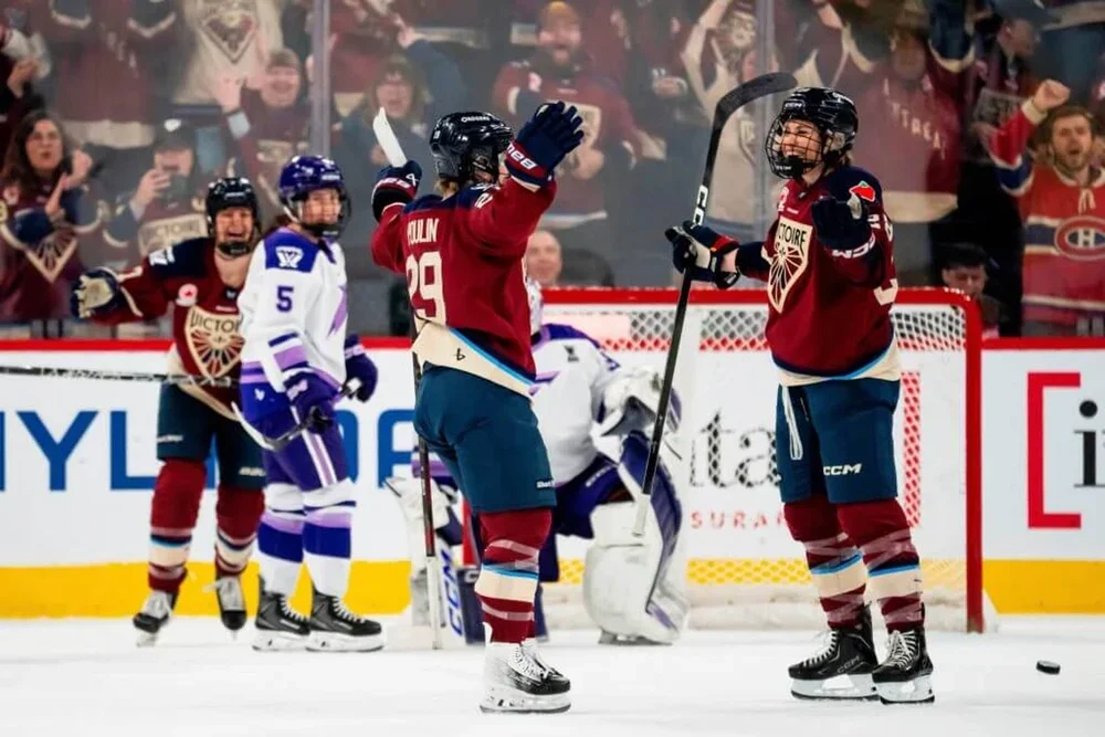 Catherine Dubois and Marie-Philip Poulin of the Motnreal Victoire celebrate a goal against the Minnesota Frost